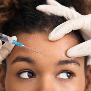 woman receiving Botox injection in forehead for wrinkle reduction and smooth skin at Howganics Med Spa