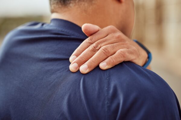 Man experiencing back pain while exercising, highlighting the benefits of Howganics PRP Therapy for pain relief and muscle recovery.
