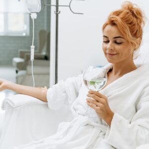 woman in bathrobe receiving "Howganics" Shot for Health Maintenance IV infusion