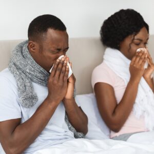 A sick man and woman in need of Howganics "How Covered" IV Drip -Immunity Defense I. A powerful blend of Vitamin C, Vitamin D3, Zinc, B-Complex, and Glutathione. This therapy is designed to strengthen your immune system