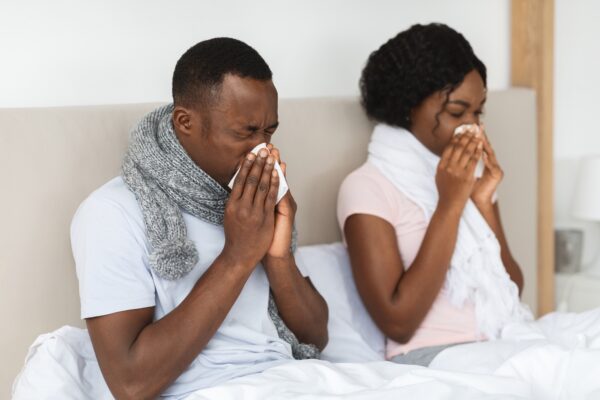 A sick man and woman in need of Howganics "How Covered" IV Drip -Immunity Defense I. A powerful blend of Vitamin C, Vitamin D3, Zinc, B-Complex, and Glutathione. This therapy is designed to strengthen your immune system