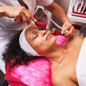 "Howganics Facial Skin Tightening treatment on African American by a skilled beauty expert