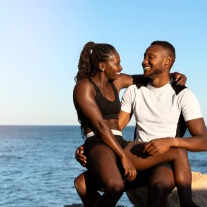 African american couple laughing and looking at each other after sport